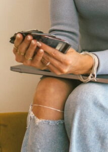 Close-up of a travel expert's hands while working on a laptop, emphasizing personalized coaching and strategic planning.