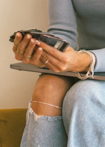 Close-up of a travel expert's hands while working on a laptop, emphasizing personalized coaching and strategic planning.