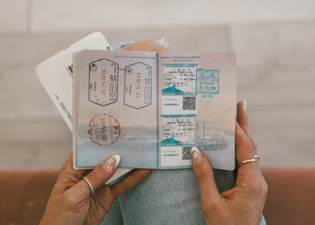 lose-up of an open passport with multiple international entry stamps from successful family trips planned by Our Family Passport.