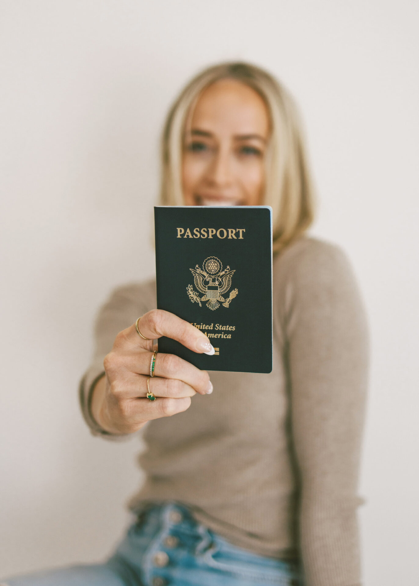 Travel blogger holding passport ready to book a flight with credit card points
