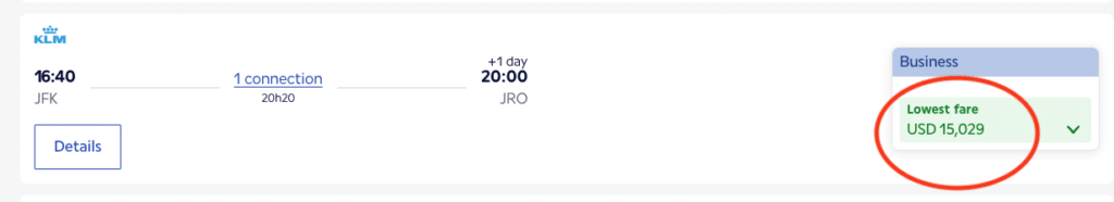 Comparison showing a $15,029 cash price for business class flights versus a $1,044 points-based redemption for two passengers.